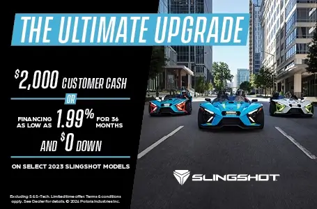 Three slingshots driving down a city street. Promotional Offer: The ultimate upgrade. Select $2,000 customer cash or financing as low as 1.99% for 36 months and $0 down on select 2023 Slingshot Models