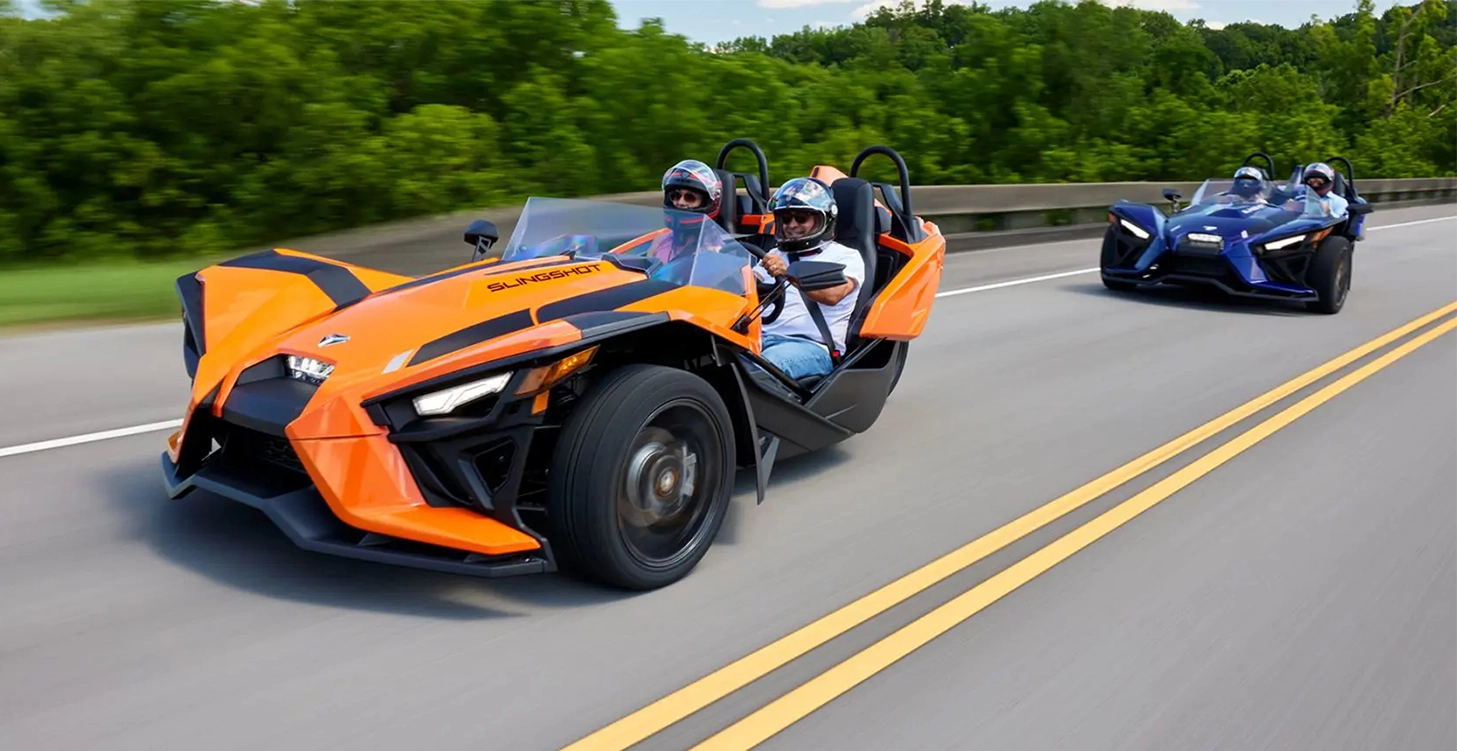 Polaris Slingshot vehicles driving down road