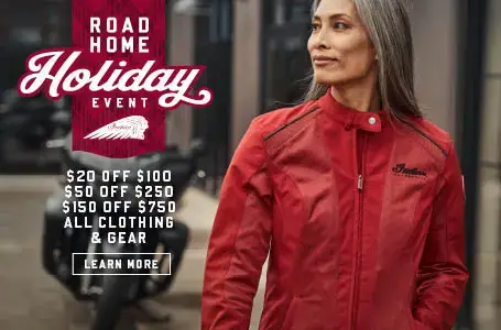 Female wearing new Indian Motorcycle Red Jacket. Promotional Offer: $20 off $100, $50 off $250, $150 off $750 all  clothing & gear.