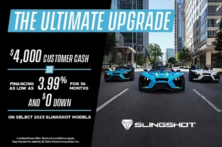 Three slingshots driving down a city street. Promotional Offer: The ultimate upgrade. Select $2,500 customer cash or financing as low as 3.99% for 36 months and $0 down on select 2023 Slingshot Models