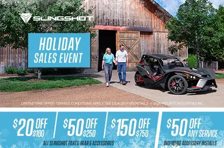 Couple walking towards Polaris Slingshot. Promotional Offer: $20 off $100, $50 off $250, $150 off $750.